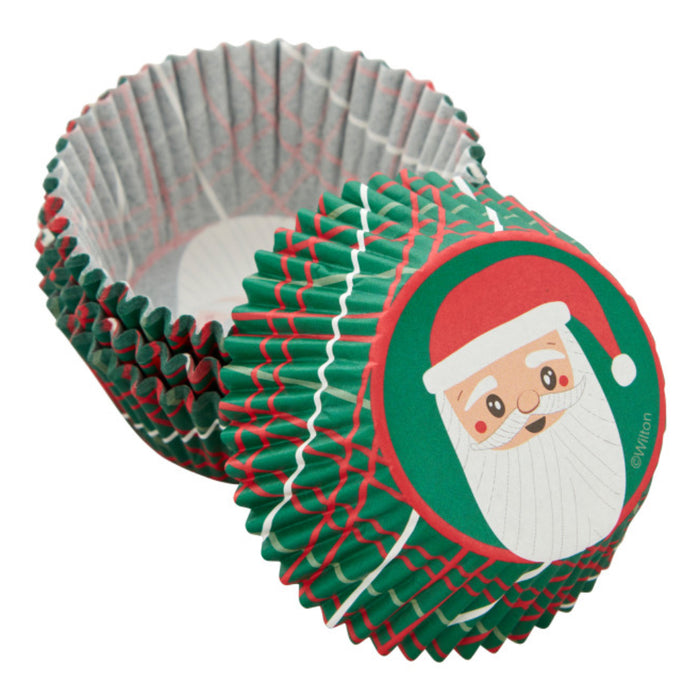 A shot of Wilton Festive Santa Claus Cupcake Liners, Pack of 75 showing the Santa Graphic on the bottom and the green, red, and white, decorations on the side on the the cups.