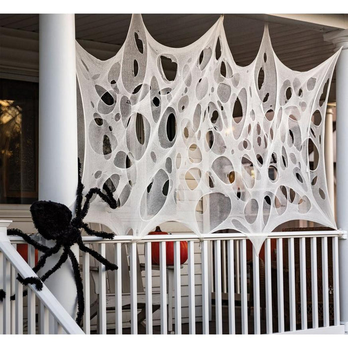 A porch featuring Halloween fabric spider webbing or beef netting.