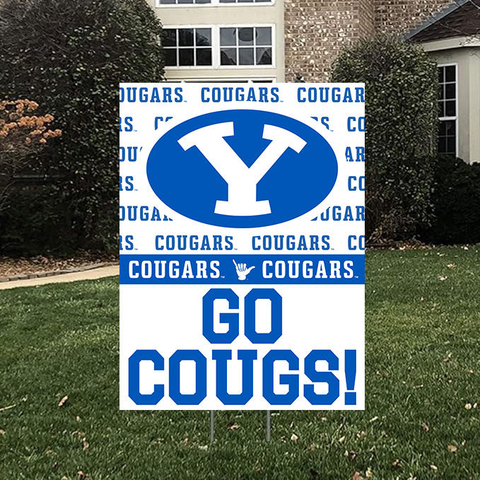 A BYU Go Cougs! Yard Sign on a yard stake in a yard in front of the house.