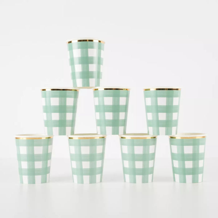 An eight pack of Meri Meri 9 ounce Christmas Green Gingham Cups stacked upon each other.